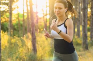 Woman Running for Charity Miles with Headphones in Her Ears